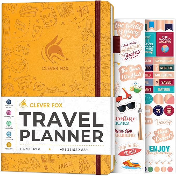 a yellow covered Clever Fox brand Travel planner with some sticker pages poking out at the back