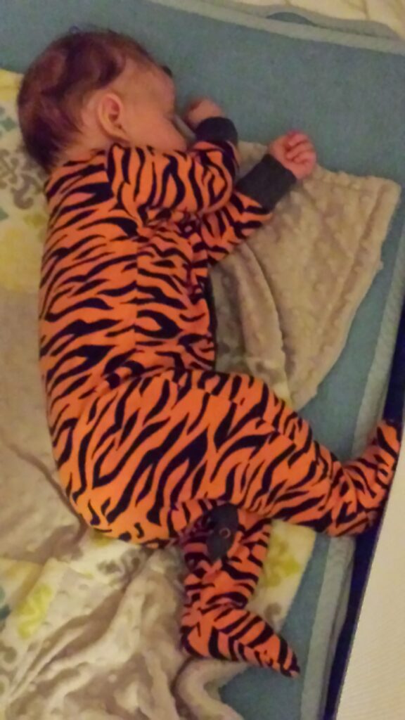 My very cute baby napping in his tiger print sleepsuit. An oldie but a goldie of a picture.