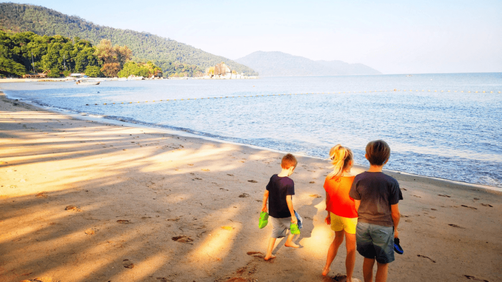 My 3 kids on the beach looking at the sea in Penang, Malaysia