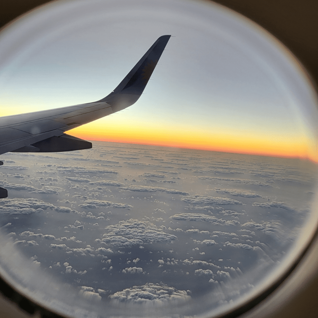 A plane wing flying over clouds at sunset - this was my view on the way to Playa de Las Americas in Tenerife summer 2024.