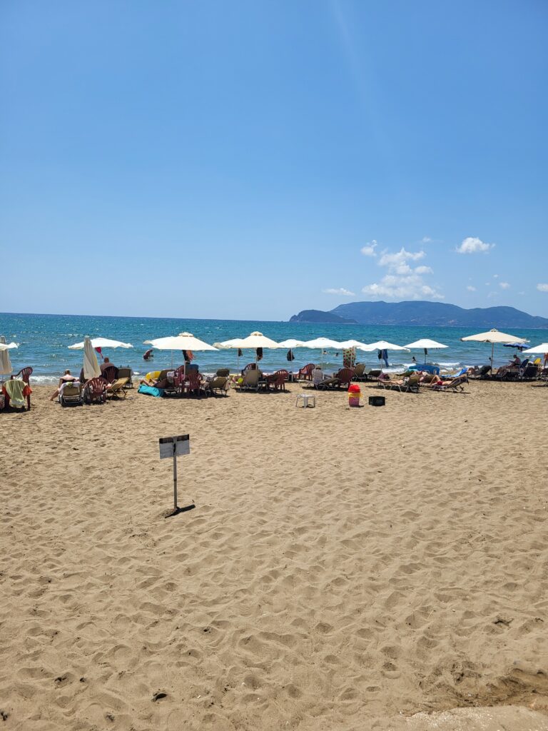 Sunbeds in a row by the sea shore at Kalamaki beach